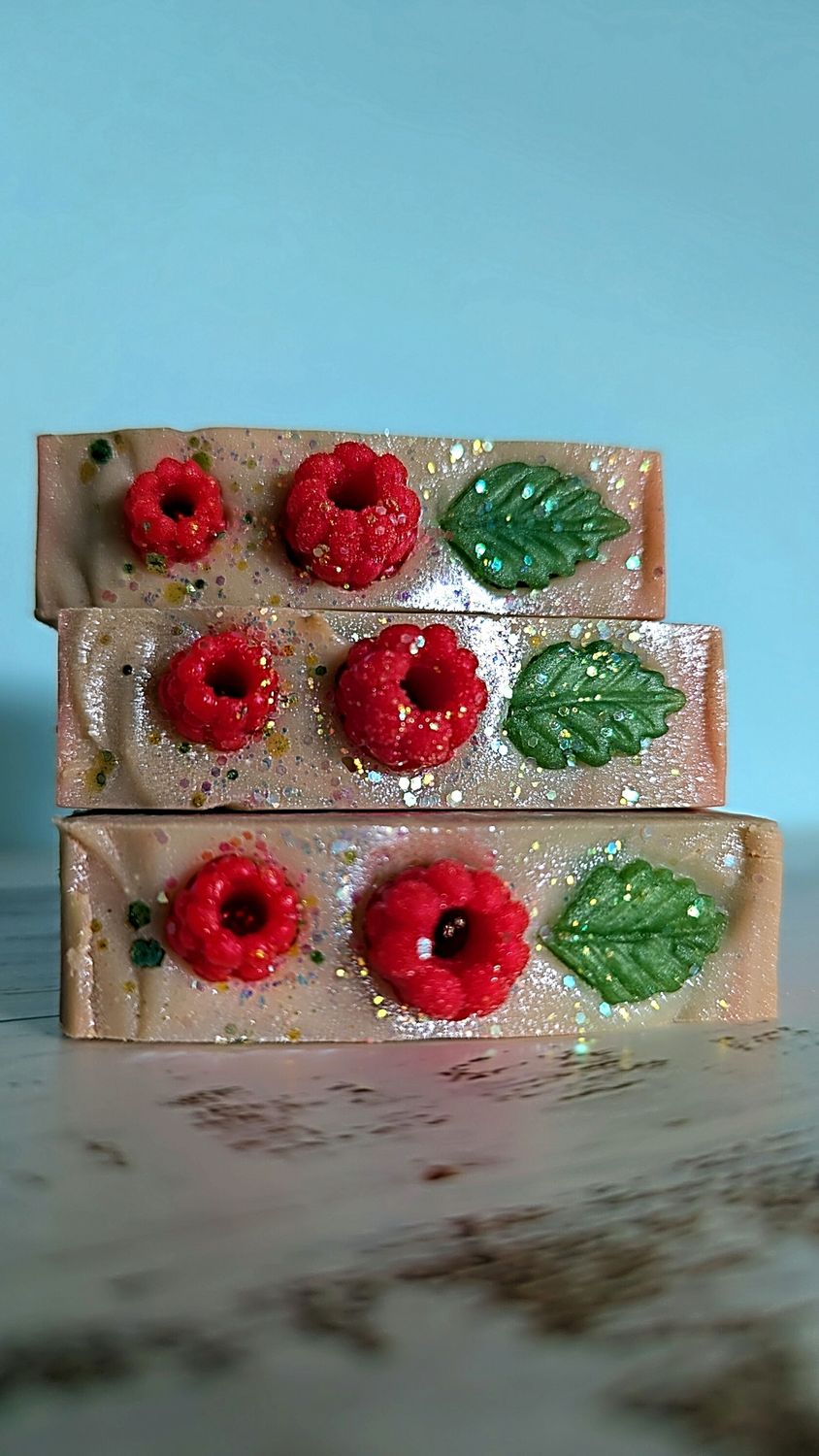 Berry Mint Soap Three stacked bars of soap decorated with red flowers and green leaves.